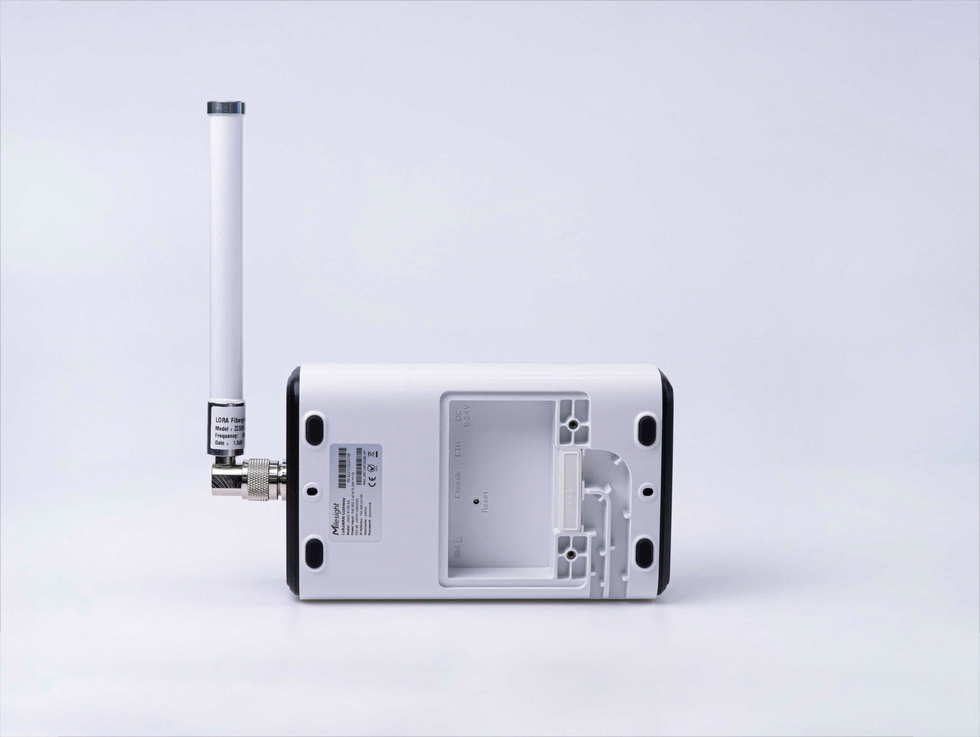 Milesight UG65 LoRaWAN gateway with external antenna, rear view with access cover removed.